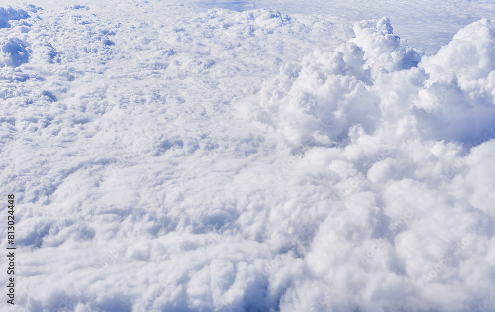 Aerial view of dense cottony cloudscape from above, showcasing the beauty of natural sky patterns and light. Aerial view of dense cottony cloudscape from above, showcasing the beauty of natural sky patterns and light.