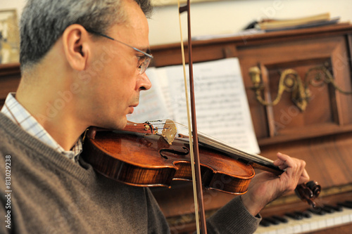 man and violin with score photo