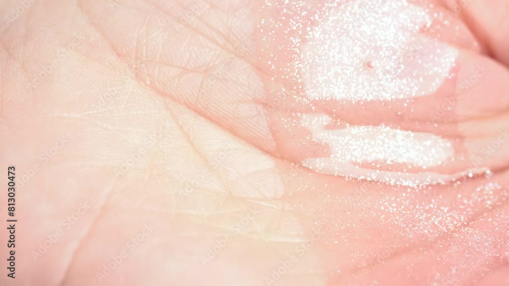 Moisturizing pink shower gel with shimmer pouring into open hand. Skin care concept Moisturizing pink shower gel with shimmer pouring into open hand. Skin care concept