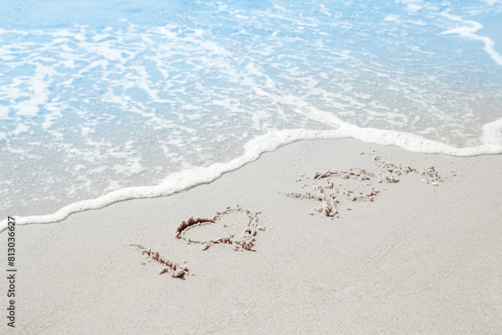 Fototapeta premium beautiful drawings inscription on the sand of the sea in the summer on the nature