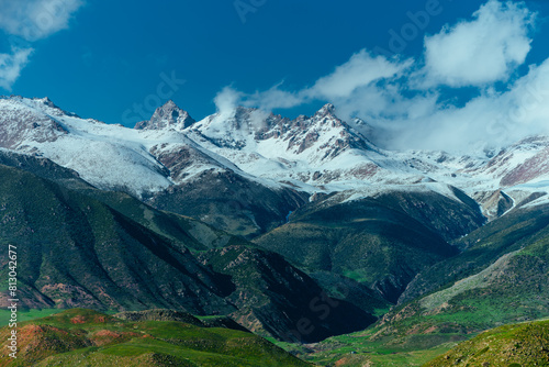 Picturesque mountain landscape with snow peaks in spring