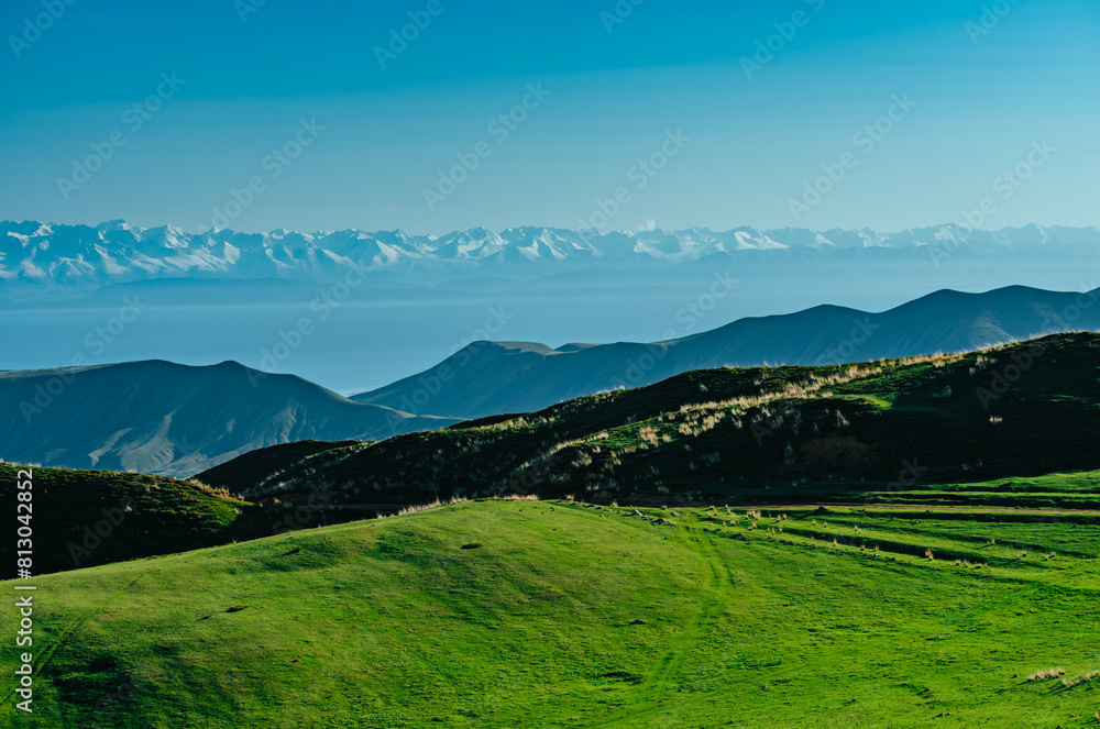 Fototapeta premium Picturesque green mountain valley and lake in the distance