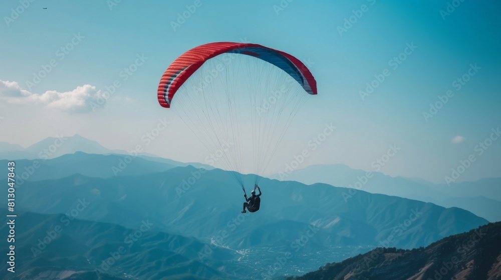 A person paragliding over a mountain range, adventure background A person paragliding over a mountain range, adventure background