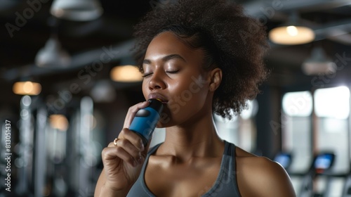 Woman Hydrating During Gym Workout photo