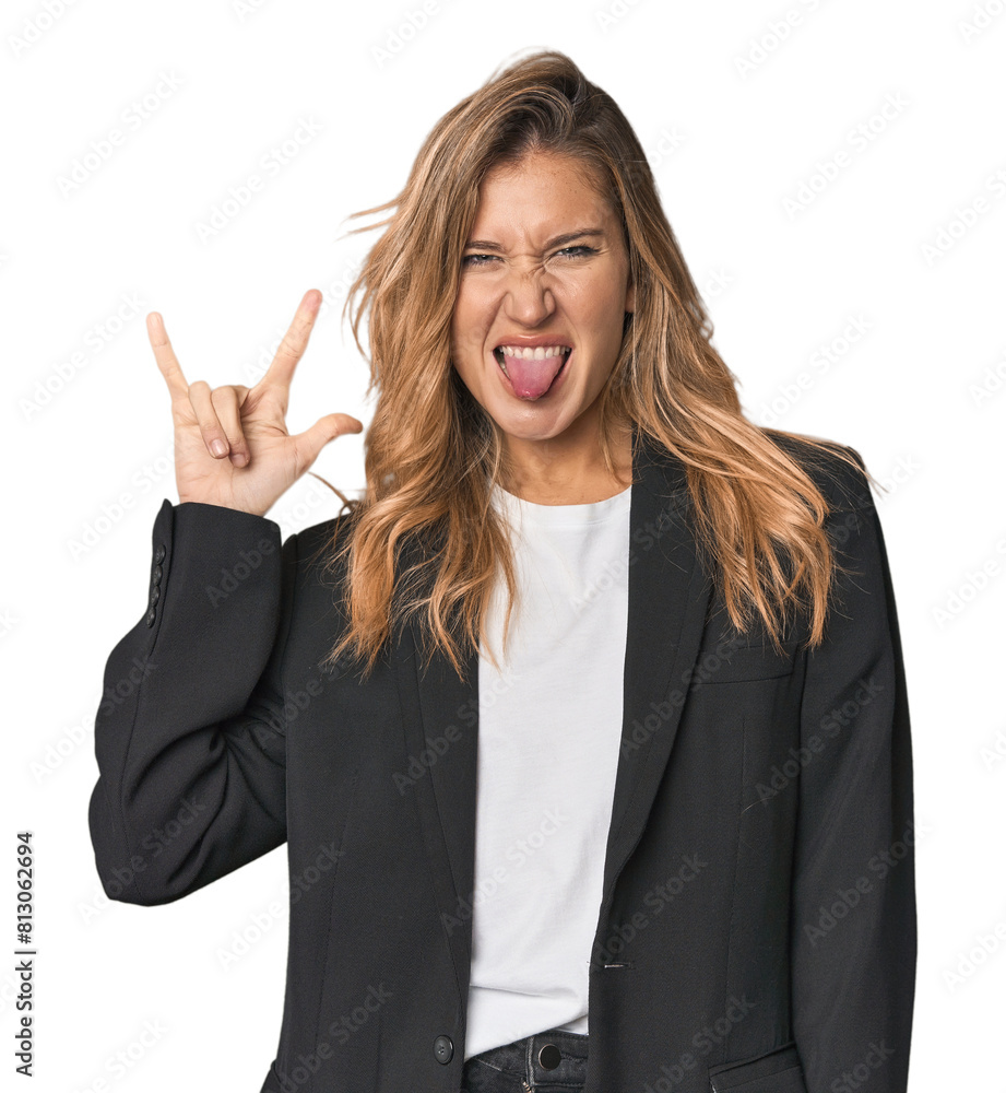 Young businesswoman in a suit showing a horns gesture as a revolution concept. Young businesswoman in a suit showing a horns gesture as a revolution concept.