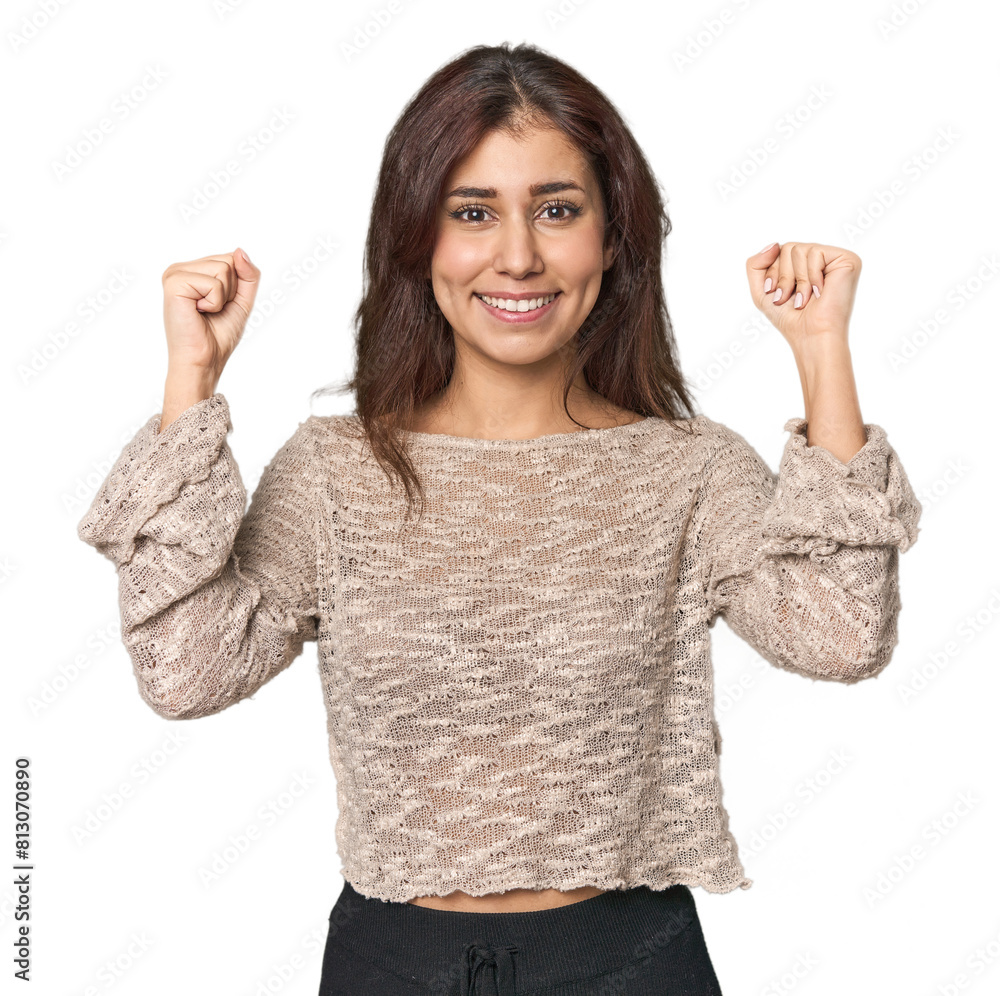 Middle Eastern woman in studio celebrating a victory, passion and enthusiasm, happy expression. Middle Eastern woman in studio celebrating a victory, passion and enthusiasm, happy expression.