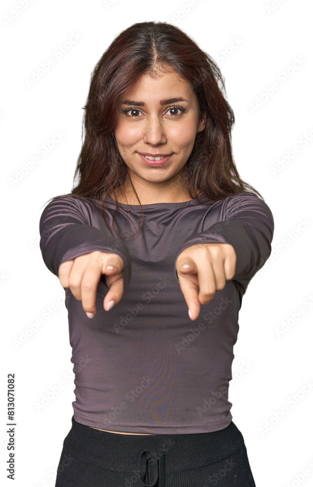 Middle Eastern woman in studio cheerful smiles pointing to front. Middle Eastern woman in studio cheerful smiles pointing to front.