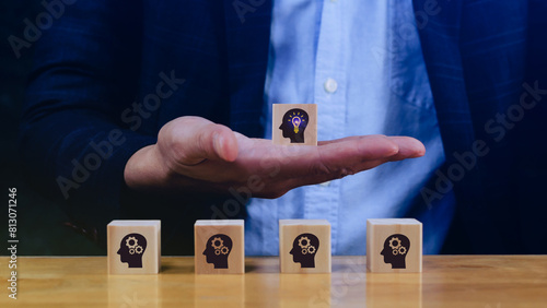 Thinking skills for business leader and manager concept. creative, systematic thinking skill, Hand business picked wooden cube block with head human symbol and light bulb icon creative idea concept.
