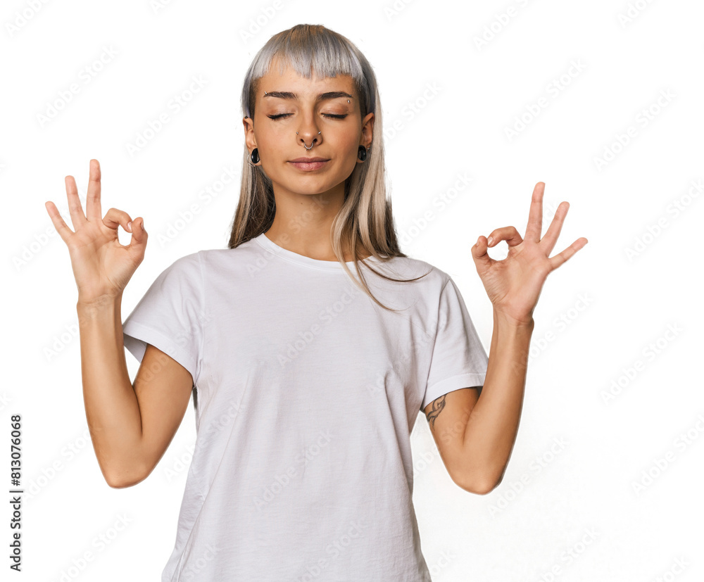 Young caucasian young woman in studio relaxes after hard working day, she is performing yoga. Young caucasian young woman in studio relaxes after hard working day, she is performing yoga.