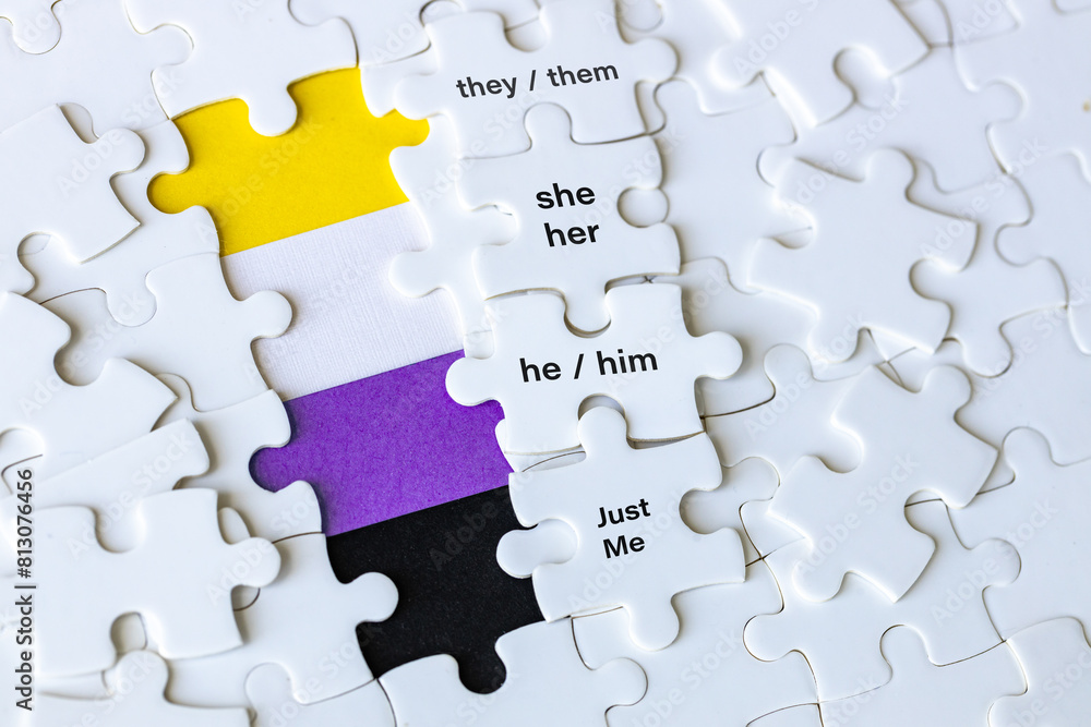 A removed puzzle showing the symbol of non-binary people and the words they them, she her, he him, just me. Concept, gender diversity, people with non-binary gender identity, transgender people.