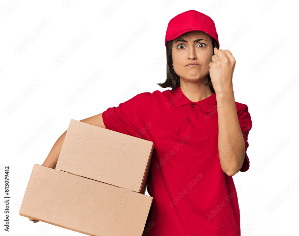 Young Caucasian delivery woman with boxes showing fist to camera, aggressive facial expression. Young Caucasian delivery woman with boxes showing fist to camera, aggressive facial expression.