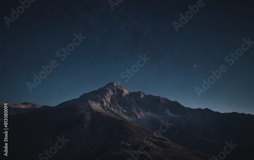 Snowcovered mountain under starry sky at night in natural landscape