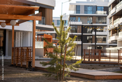 A modern  environmentally friendly  landscaped area with a wide avenue and green areas and modern residential buildings