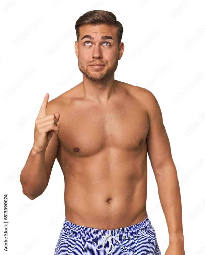 Fototapeta premium Young man shirtless in swimwear, studio having some great idea, concept of creativity.