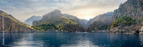 Bild auf Leinwand Cala de Sa Calobra bay from the sea, bathed in morning sunlight, framed by Serra de Tramuntana mountains, ideal for promoting tranquil vacations, coastal exploration and nature tourism in Mallorca