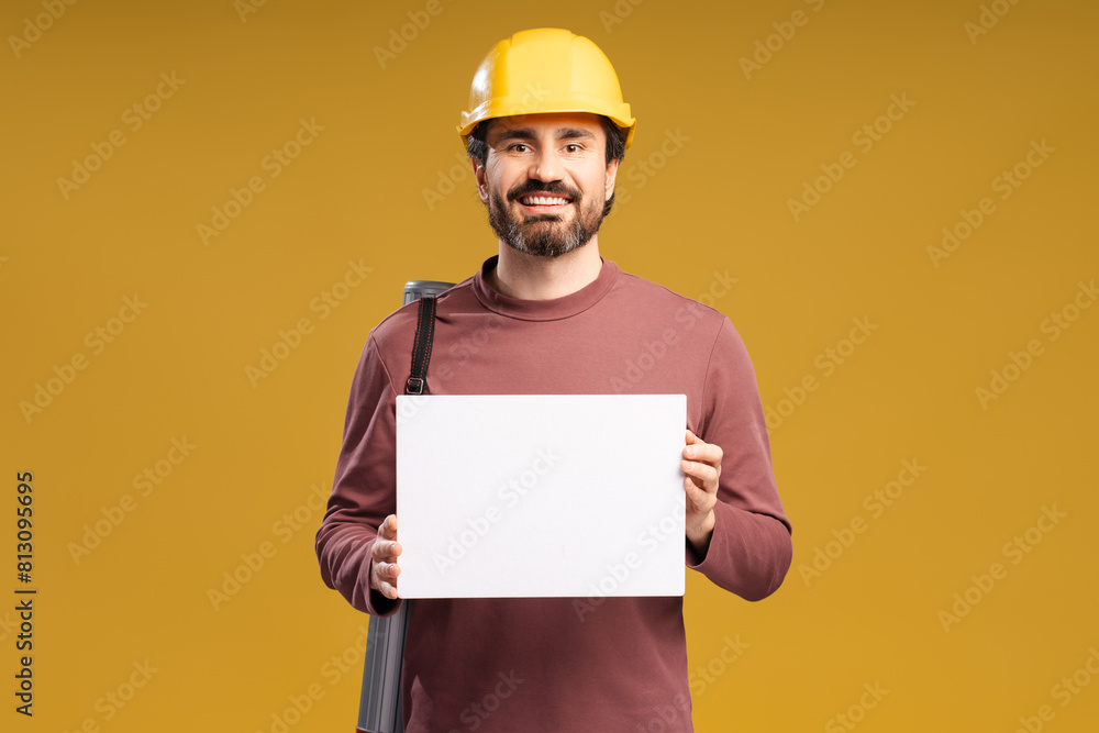 Cheerful bearded man builder holding copy space blank, looking at camera, isolated Cheerful bearded man builder holding copy space blank, looking at camera, isolated