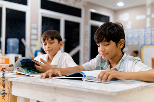 Portrait school boy reading a book.