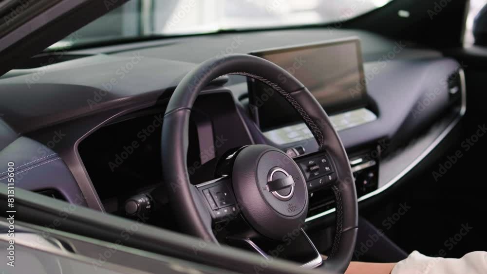 Close-up of a young woman's hands driving an electric car. The concept of buying a new car, modern automotive technology and car service. Close-up of a young woman's hands driving an electric car. The concept of buying a new car, modern automotive technology and car service.