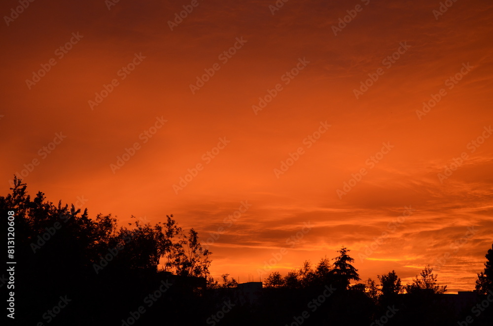 Bright orange sunset over the evening city