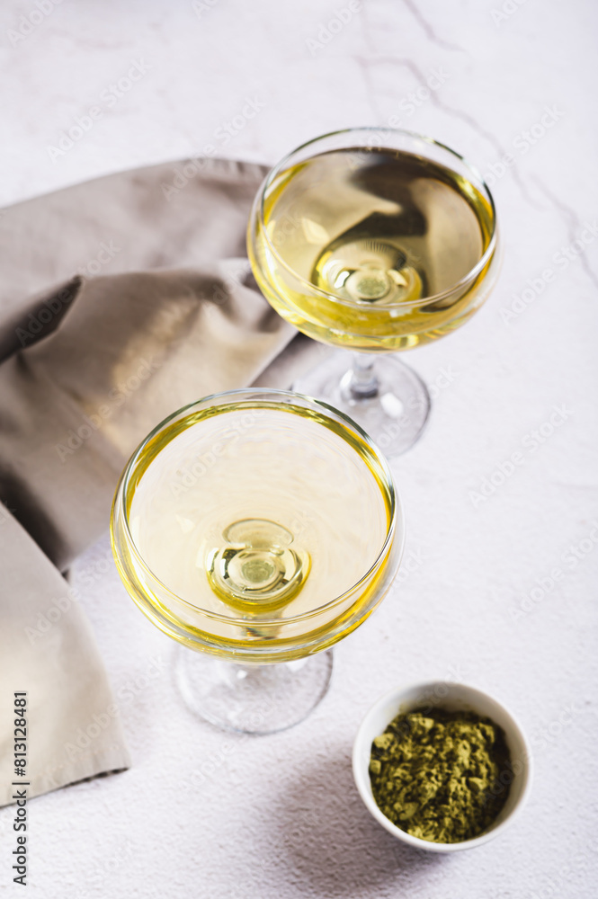 Refreshing green matcha martini in glasses on the table vertical view Refreshing green matcha martini in glasses on the table vertical view