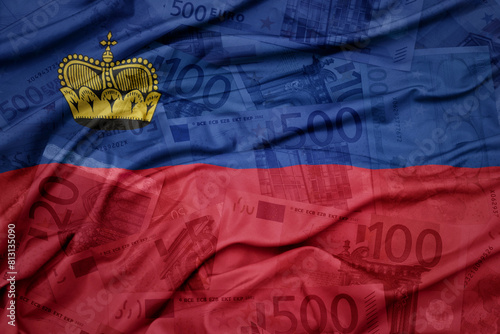 waving colorful national flag of liechtenstein on a euro money banknotes background. finance concept.