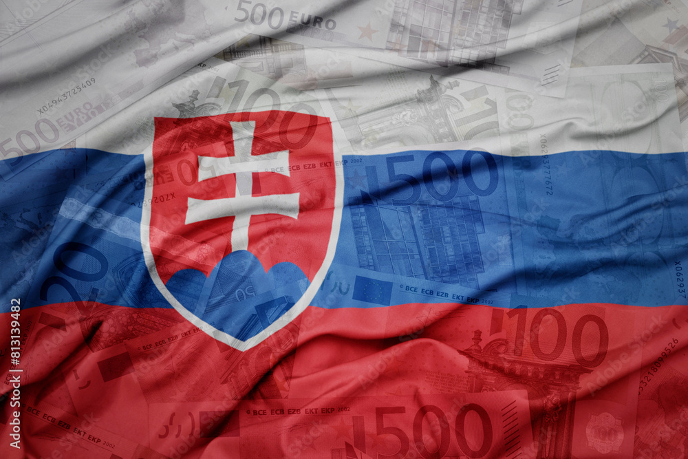Fototapeta premium waving colorful national flag of slovakia on a euro money banknotes background. finance concept.