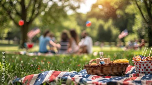 picnic basket with food on green lawn on american flag background, independence day concept. there is a group of people in the background. with space for text