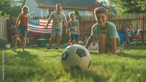 boys running after a soccer ball, children playing on the backyard lawn at home, independence day concept