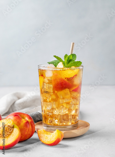 Refreshing peach iced mint tea. The concept of a healthy homemade cold summer drink