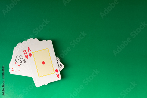 Playing cards isolated on green background.