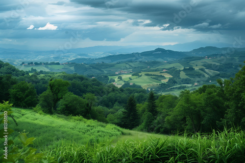 photograph of green hills and fields with trees, clouds in the sky, dark blue mountains in the background, hills of the Emiliauso region of Italy, in the style of Emira di Pissiwave, detailed landscap