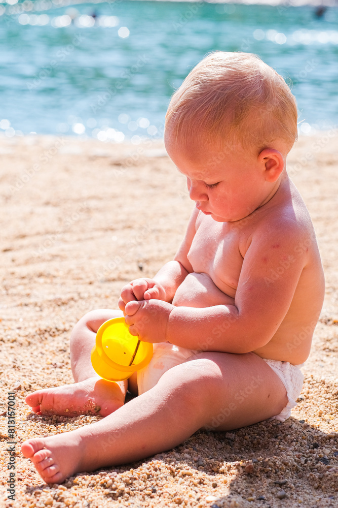 A girl is playing on the beach sand with the sunny day A girl is playing on the beach sand with the sunny day