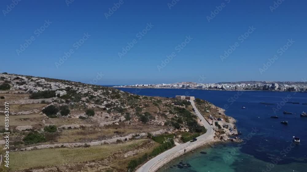 Aerial view of Mistra battery from Mistra bay. Qawra aquarioum and Bugibba promenade in the distance. . High quality FullHD footage Aerial view of Mistra battery from Mistra bay. Qawra aquarioum and Bugibba promenade in the distance. . High quality FullHD footage