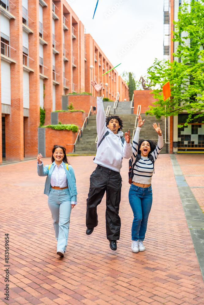 Fototapeta premium Students throwing folders celebrating the end of the course