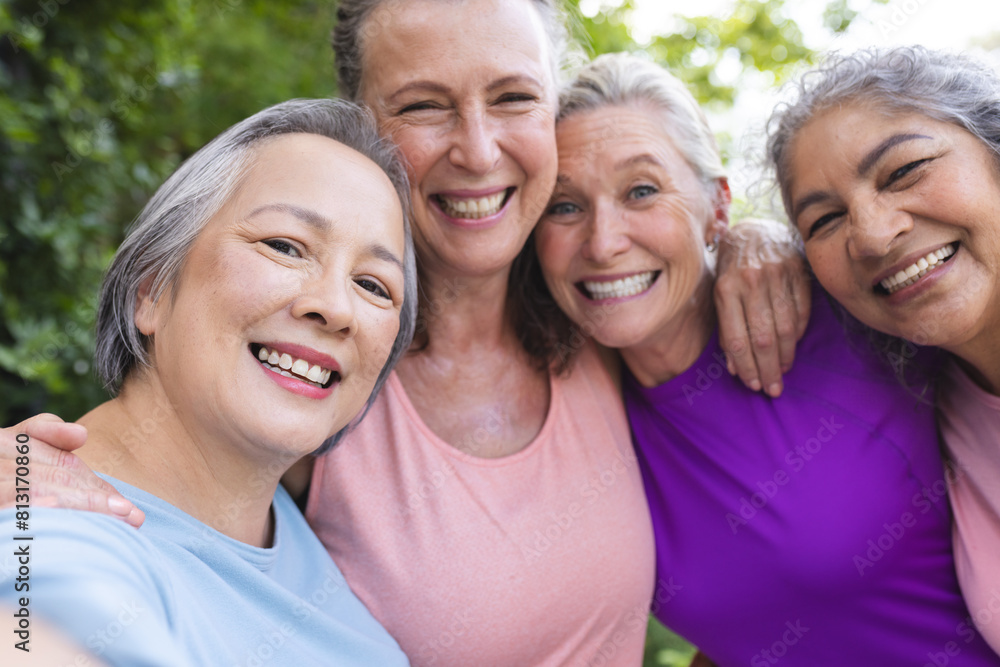 Outdoors, diverse senior female friends smiling together Outdoors, diverse senior female friends smiling together