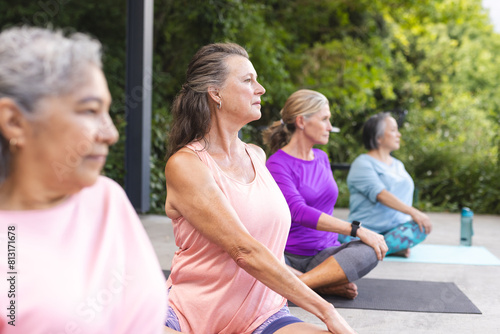 Outdoors  diverse senior female friends practicing yoga