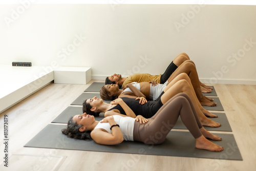 Group of people in a relaxation pose on yoga mats