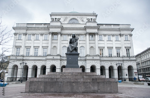 Statue of Nicolaus Copernicus with the facade of the Society of Friends of Science in the city of Warsaw, Poland