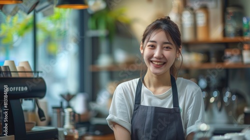 A Smiling Young Asian Barista Eagerly Awaits Clients At A Coffee Shop, Her Friendly Demeanor Inviting Customers To Enjoy Their Experience