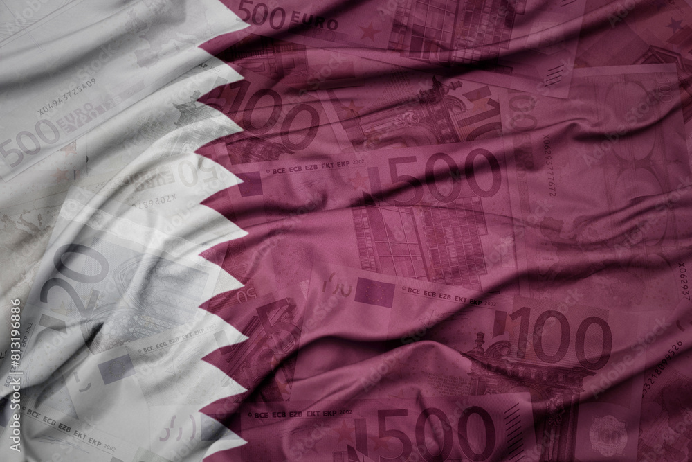 waving colorful national flag of qatar on a euro money banknotes background. finance concept. waving colorful national flag of qatar on a euro money banknotes background. finance concept.