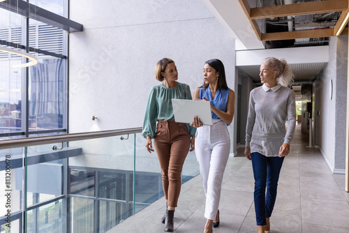 Diverse team of middle-aged Caucasian and biracial pros walking at office
