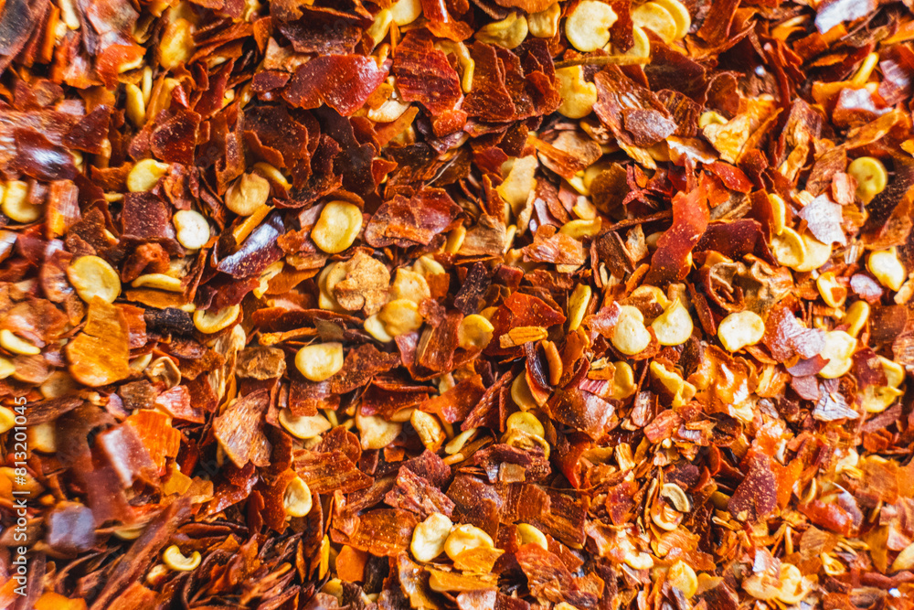 Dried red chili flakes with seeds background. Chopped chilli cayenne pepper. Spices and herbs Dried red chili flakes with seeds background. Chopped chilli cayenne pepper. Spices and herbs