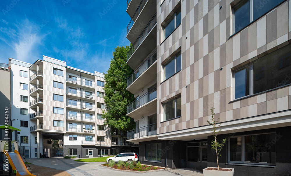 Fototapeta premium Courtyard and fasade of a modern residential house in a European city.