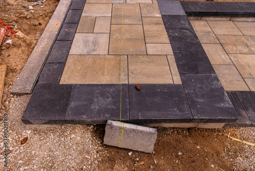 Canvas Print home construction: patio and walkway paving stone instalation in progress at a n