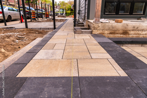 Photography home construction: patio and walkway paving stone instalation in progress at a n