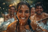 The face of a joyful woman splashed by water, with friends in the blurry background