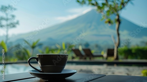 Close up a cup of black coffee and Slamet montain on the background photo