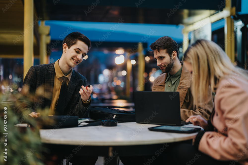 Three business professionals sit at a cafe with digital devices, engaged in a strategic business discussion. Three business professionals sit at a cafe with digital devices, engaged in a strategic business discussion.