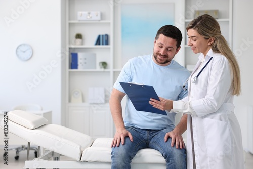 Professional doctor working with patient in hospital, space for text © New Africa