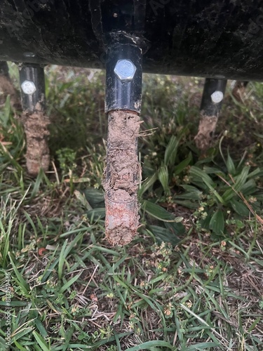 Close up of core aerator tine from lawn aerator with core